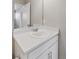 Bathroom featuring a vanity with a white countertop, ample cabinet space, and a framed mirror at 21823 E 8Th Ave, Aurora, CO 80018