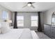 Spacious bedroom boasts ample natural light and features a ceiling fan, dresser, and plush carpeting at 21823 E 8Th Ave, Aurora, CO 80018