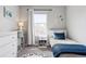 Bedroom featuring a twin bed, a colorful bookshelf, and soft, patterned carpeting at 21823 E 8Th Ave, Aurora, CO 80018
