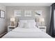 Bright bedroom features a comfortable bed with crisp white linens, complemented by stylish bedside lamps at 21823 E 8Th Ave, Aurora, CO 80018