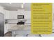 Modern kitchen boasts white cabinetry, stainless steel appliances, and a granite-topped island with seating at 21823 E 8Th Ave, Aurora, CO 80018