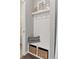 Bright mudroom featuring a convenient bench with storage baskets and coat hooks for organization at 21823 E 8Th Ave, Aurora, CO 80018