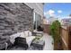 Cozy patio with stone accent wall, furniture, and grill, perfect for outdoor living at 21823 E 8Th Ave, Aurora, CO 80018
