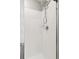 Shower showcasing white tiled walls, a chrome shower head, and a glass door enclosure at 21823 E 8Th Ave, Aurora, CO 80018
