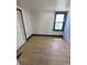 Cozy bedroom featuring light wood flooring and window with white trim at 1368 Joliet St, Aurora, CO 80010