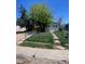 Modest single-story home with a chain link fence and mature tree at 1368 Joliet St, Aurora, CO 80010