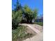 Modest single-story home with a chain link fence and mature trees at 1368 Joliet St, Aurora, CO 80010