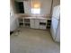 Simple kitchen with white cabinets, vintage countertops, and a refrigerator at 1368 Joliet St, Aurora, CO 80010