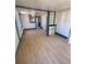 Living room with light wood flooring and window with white trim at 1368 Joliet St, Aurora, CO 80010