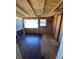 Unfinished room with wood paneled walls and wood floors, ready to be refinished at 1368 Joliet St, Aurora, CO 80010