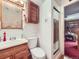 Cozy bathroom featuring a shower with glass doors and charming wood accents at 2220 W 73Rd Pl, Denver, CO 80221