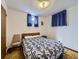 Simple bedroom featuring a floral bedspread, neutral walls, and carpeted floors at 2220 W 73Rd Pl, Denver, CO 80221