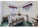 Inviting bedroom with a white iron bed frame and bright, airy feel at 2220 W 73Rd Pl, Denver, CO 80221