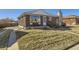 Brick home with a stone chimney, well-maintained lawn, and spacious front yard at 2220 W 73Rd Pl, Denver, CO 80221