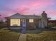 Charming brick home with stone chimney, front bench, and ample natural light at 2220 W 73Rd Pl, Denver, CO 80221