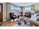 Inviting living room featuring large windows, hardwood floors, and comfortable seating at 2220 W 73Rd Pl, Denver, CO 80221