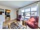 Bright living room with hardwood floors, large windows, and comfortable seating area at 2220 W 73Rd Pl, Denver, CO 80221