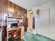 Functional home office space with wood-paneled walls, built-in shelving, and a comfortable workspace at 2220 W 73Rd Pl, Denver, CO 80221