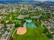 Stunning aerial view showcasing a park with a lake, sports fields, and lush greenery at 1070 S Newton St, Denver, CO 80219