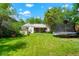 Spacious backyard with a lush lawn, mature trees, and outdoor seating, perfect for entertaining at 1070 S Newton St, Denver, CO 80219