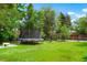 Large backyard with a trampoline and lush green grass, great for outdoor activities at 1070 S Newton St, Denver, CO 80219