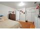 Bedroom features a dark wood dresser, closet, bed, and hardwood floors with area rug at 1070 S Newton St, Denver, CO 80219