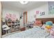 Inviting bedroom with shelves, a bed, and a view to the doorway at 1070 S Newton St, Denver, CO 80219