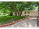 Charming home featuring a well-maintained lawn, mature trees, and a driveway at 1070 S Newton St, Denver, CO 80219