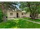 Charming home with a well-maintained front yard, mature trees, and inviting entrance with a lovely green lawn at 1070 S Newton St, Denver, CO 80219