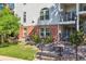 Exterior view from the backyard featuring a bench, landscaping, and building facade at 1878 S Cole St, Lakewood, CO 80228