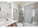 Bathroom with a shower over the bath, white cabinets and vanity with a sink at 1878 S Cole St, Lakewood, CO 80228