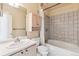 Cozy bathroom with a shower-tub combo and storage cabinet at 1878 S Cole St, Lakewood, CO 80228