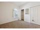 Bright bedroom features neutral walls, carpet, a closet, and a window allowing natural light at 1878 S Cole St, Lakewood, CO 80228