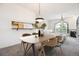 Open dining area features modern lighting and seamlessly connects to a living space and kitchen at 1878 S Cole St, Lakewood, CO 80228