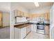 This kitchen offers wood cabinets, stainless steel appliances and tile flooring at 1878 S Cole St, Lakewood, CO 80228