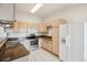 This kitchen offers wood cabinets, stainless steel appliances and tile flooring at 1878 S Cole St, Lakewood, CO 80228