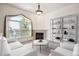 Cozy living area featuring a fireplace, bright window, and ample space for relaxing and entertaining at 1878 S Cole St, Lakewood, CO 80228