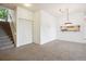 Open-concept living area with staircase and seamless flow between rooms at 1878 S Cole St, Lakewood, CO 80228
