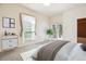 A bright main bedroom with a large window, neutral tones and access to a private balcony at 1878 S Cole St, Lakewood, CO 80228
