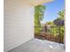 View from the patio, with black metal railing overlooking neighboring yards and lush trees at 1878 S Cole St, Lakewood, CO 80228
