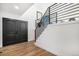 Bright foyer featuring modern staircase with a steel railing and black double doors at 10694 Camelot Dr, Franktown, CO 80116