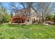 Lush backyard with a spacious lawn and a two-story deck perfect for outdoor entertaining at 9536 W Avalon Dr, Littleton, CO 80127