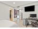 Finished basement showcasing a recreational space, including a workstation, TV and a doorway leading to another room at 9536 W Avalon Dr, Littleton, CO 80127