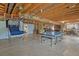 Unfinished basement featuring open ceiling, concrete floor, ping pong table and potential for customization at 9536 W Avalon Dr, Littleton, CO 80127