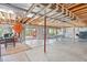 Unfinished basement featuring open joists, concrete floors, outdoor access and potential for creative customization at 9536 W Avalon Dr, Littleton, CO 80127