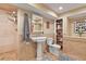 Bathroom featuring a tiled shower, pedestal sink, storage shelves, and a decorative sign at 9536 W Avalon Dr, Littleton, CO 80127