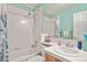 Bathroom features tiled shower and tub, complemented by a vanity with a sink and a decorative shower curtain at 9536 W Avalon Dr, Littleton, CO 80127
