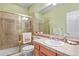 Bathroom with a shower, vanity, and peach tile at 9536 W Avalon Dr, Littleton, CO 80127