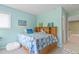 Cozy bedroom with patterned bedding, decorative pillows, and a built-in headboard with shelving for personalized decor at 9536 W Avalon Dr, Littleton, CO 80127