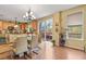 Well-lit dining area with access to a deck, featuring hardwood floors and stylish light fixtures at 9536 W Avalon Dr, Littleton, CO 80127